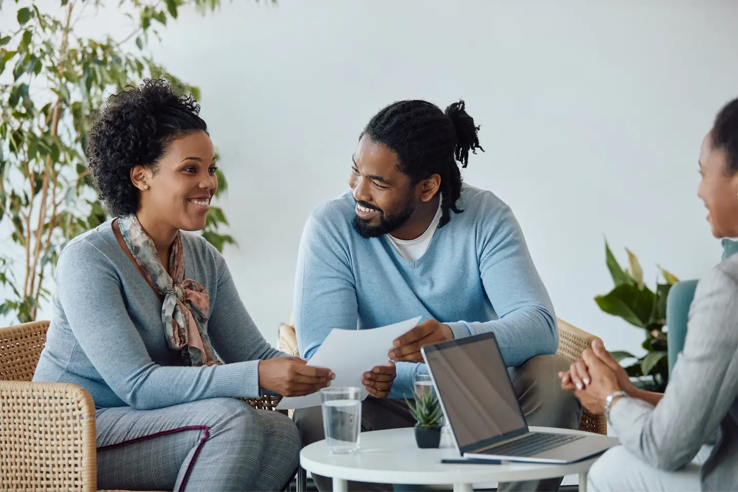 Happy black couple having meeting with their financial advisor in the office